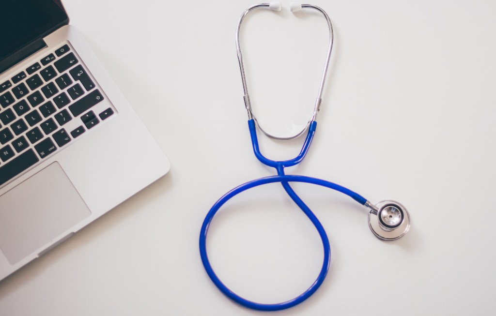 Physician reviewing tax records and independent-practice finances on a laptop