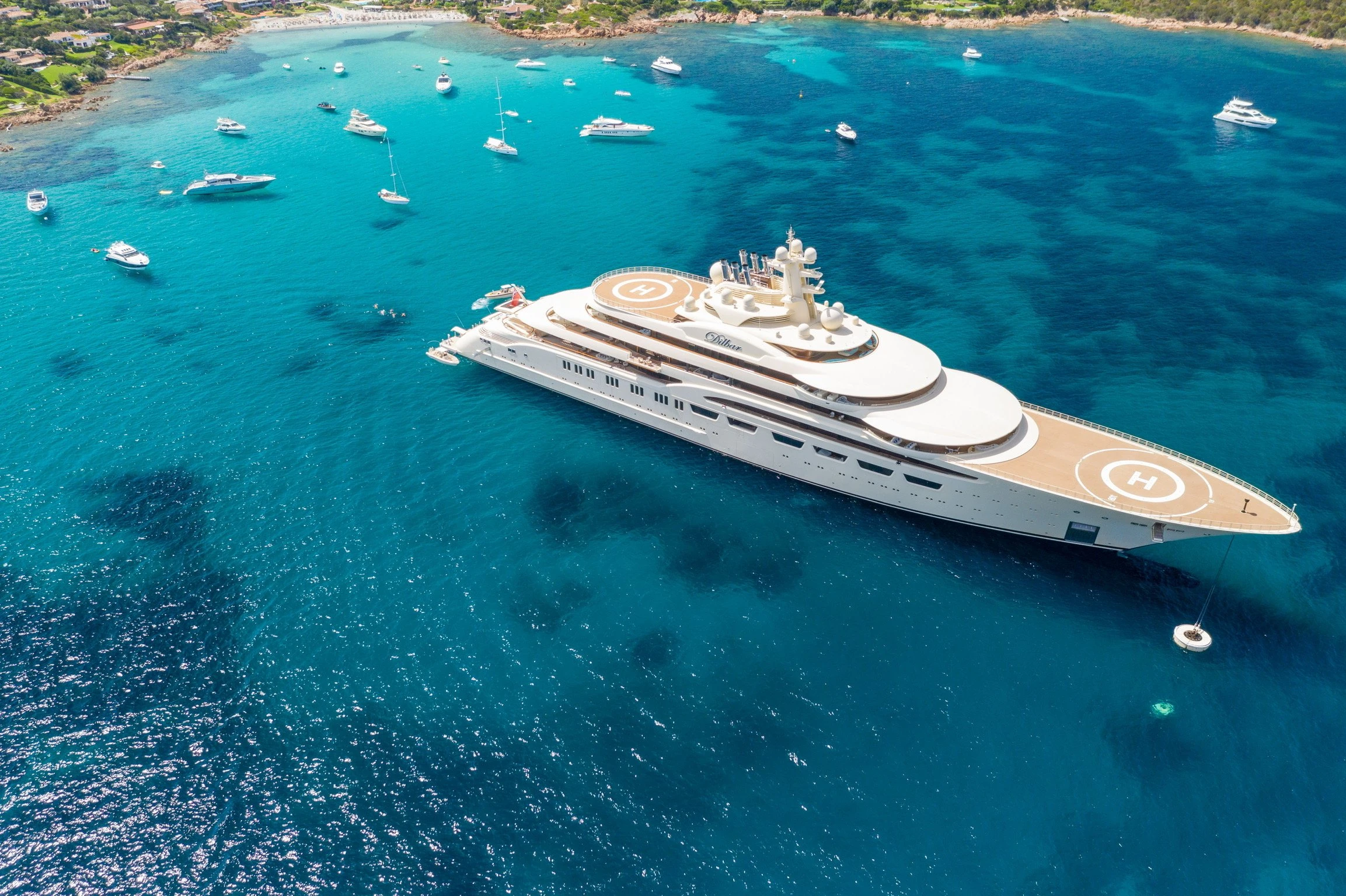 Superyacht at anchor in turquoise water — yacht owner tax, accounting, and financial services